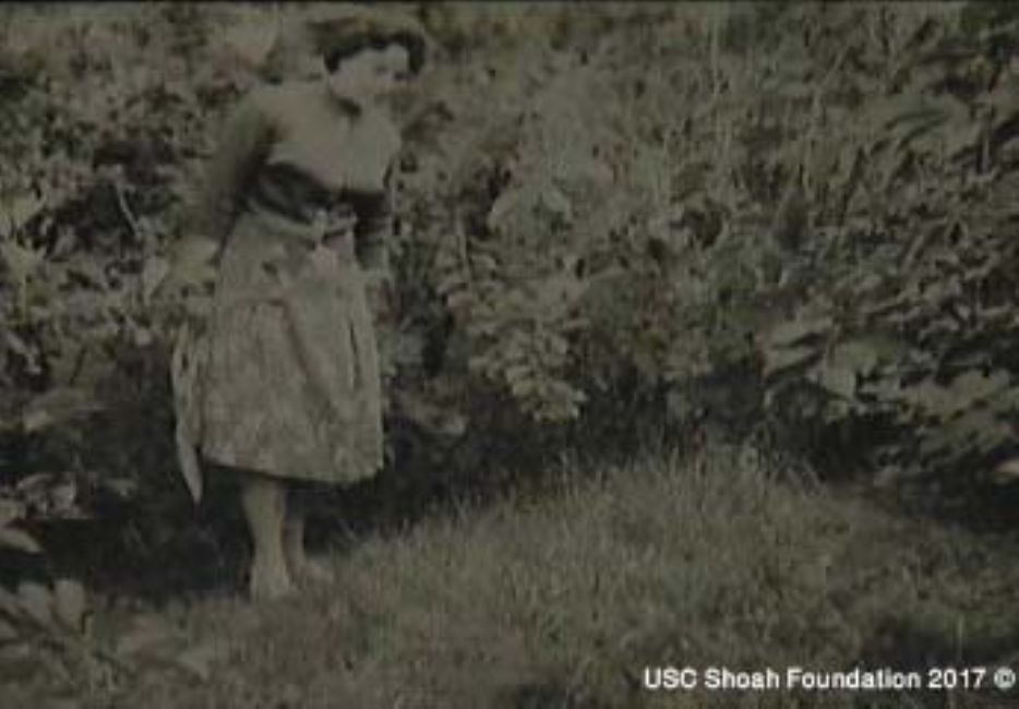 The Holocaust survivor Klara Vinokur at the murder site near the Brodetsk labor camp. A photograph from the interview with Klara Vinokur, USC Shoa Foundation Institute, copy YVA O.93/23060