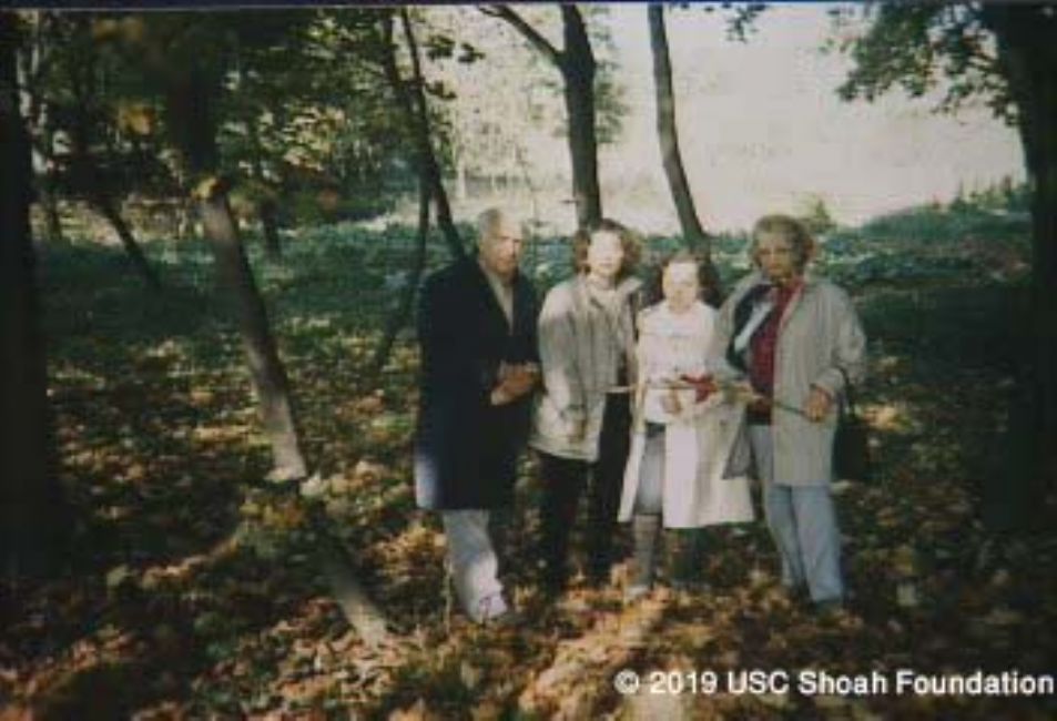 Holocaust survivors Michel and Sophy Ginsberg, their daughter, and the daughter of their Ukrainian rescuers, at the mass grave in Petrykow. A photograph from the interview with Sophy Ginsberg, USC Shoa Foundation Institute, copy YVA O.93/11044